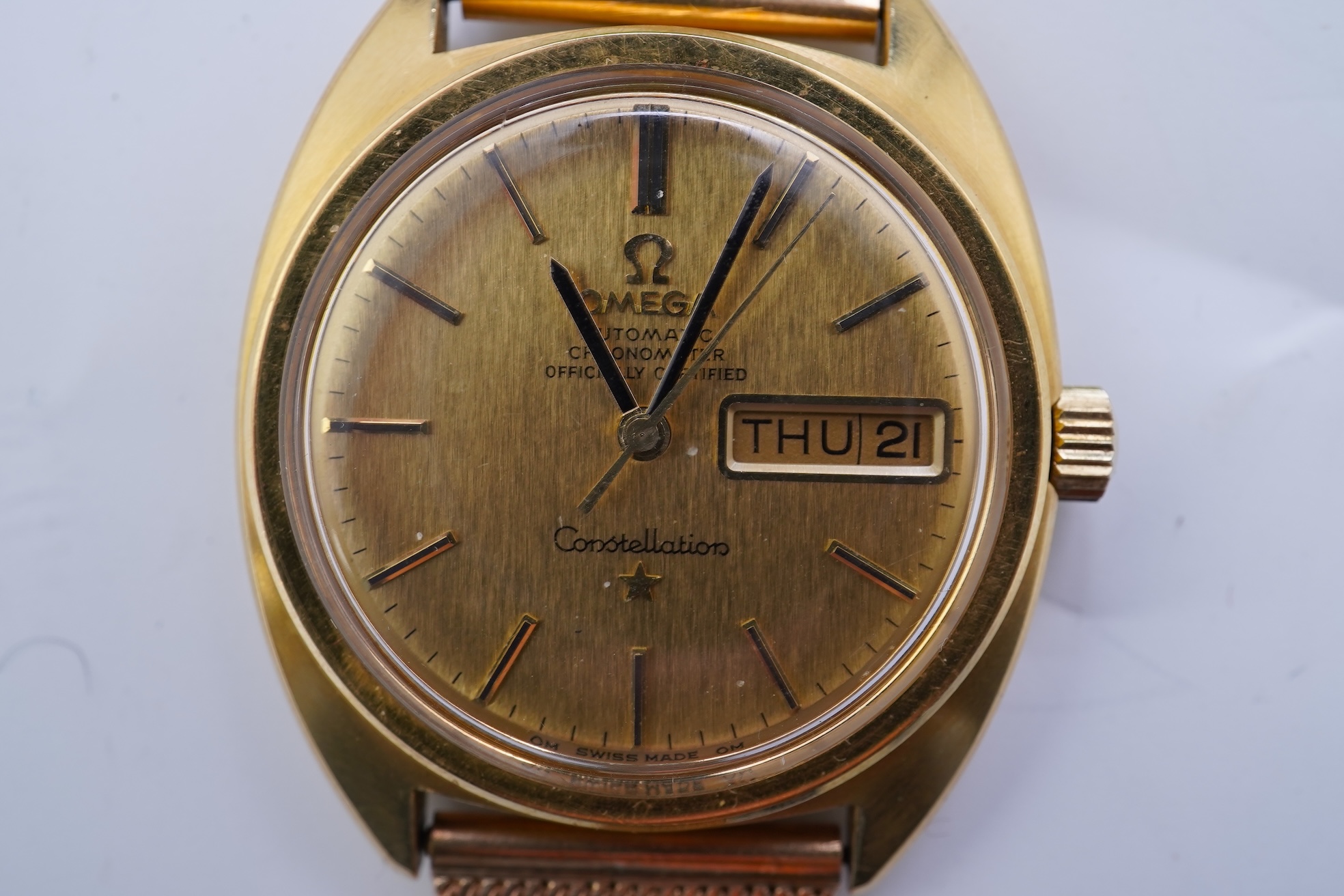 A gentleman's late 1960's 18ct gold Omega Constellation Automatic Chronometer Officially Certified wrist watch, on an associated 9ct gold mesh link bracelet